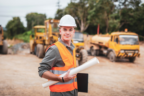 Caucasian,Handsome,Engineer,Is,Stand,And,Smile,Holding,A,Laptop